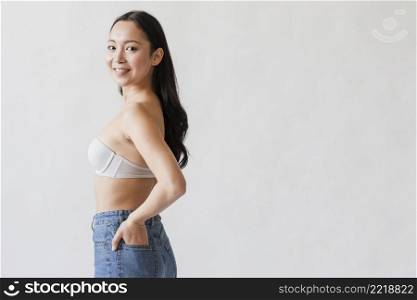 confident asian woman posing bra jeans