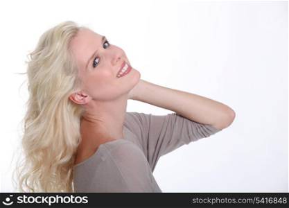 Confident blond woman posing on a white background