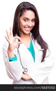 Confident brunette doctor doing ok sign over white