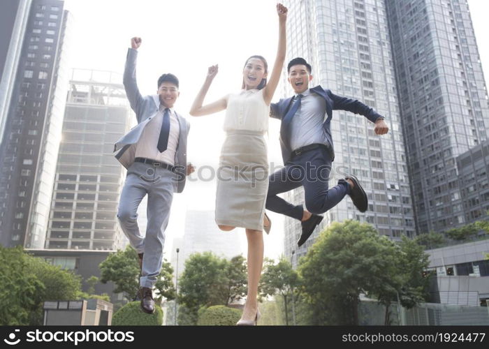 Confident business team jumping