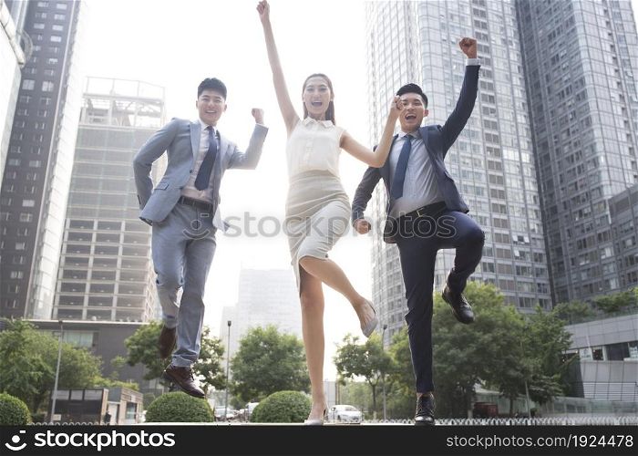 Confident business team jumping
