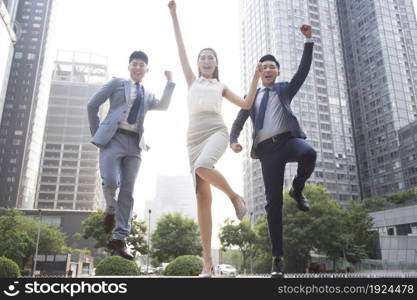 Confident business team jumping