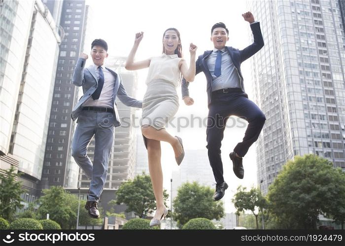 Confident business team jumping