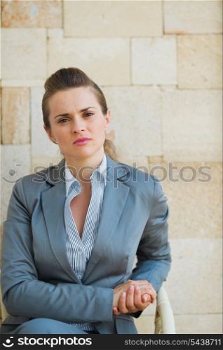 Confident business woman sitting on terrace