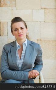 Confident business woman sitting on terrace