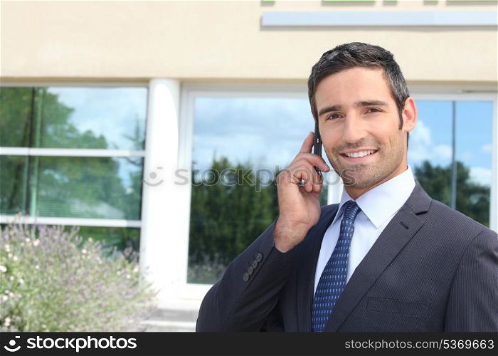 Confident businessman chatting on phone