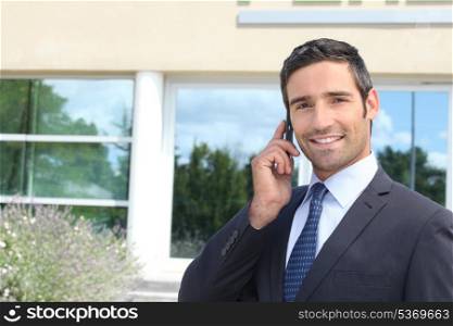 Confident businessman chatting on phone