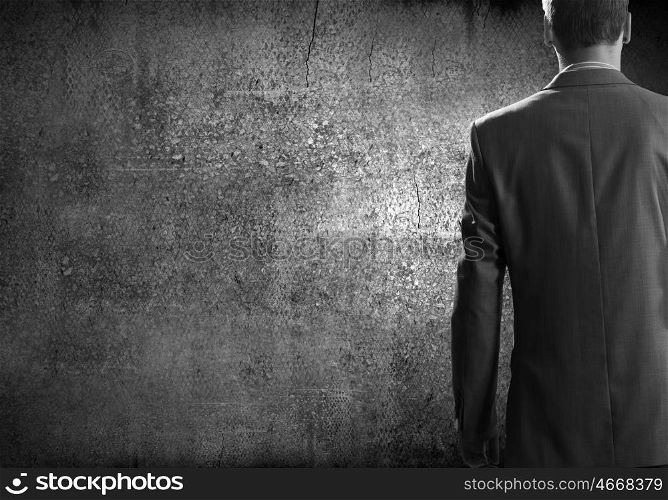 Confident businessman. Chest view of businessman against cement wall
