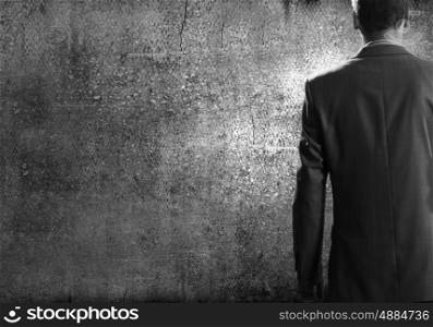 Confident businessman. Close up of businessman body in suit against cement background