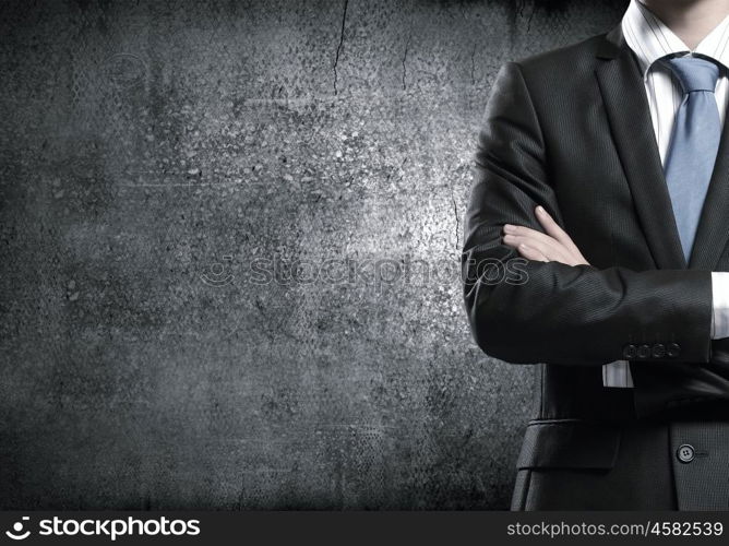 Confident businessman. Close up of businessman with arms crossed on chest