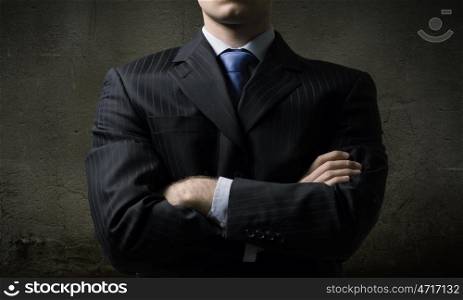 Confident businessman. Close up of businessman with arms crossed on chest