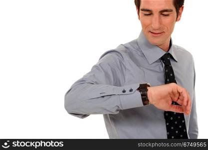confident businessman consulting his watch