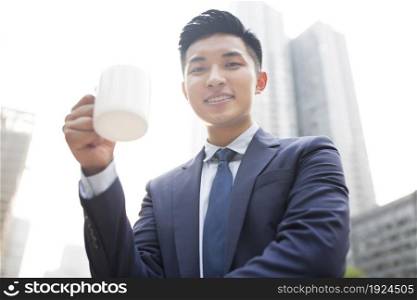 Confident businessman drinking coffee
