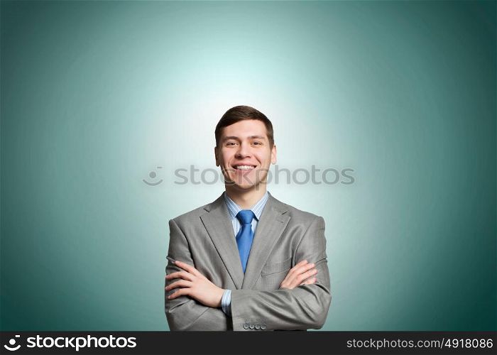 Confident businessman. Happy businessman with arms crossed on the chest