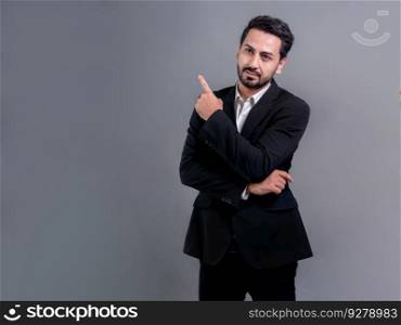 Confident businessman in formal suit pointing finger up to indicate promotion or advertising with excited and amazed facial expression and gesture on isolated background. Fervent. Confident businessman in formal suit pointing finger. Fervent