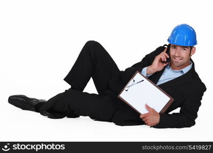Confident businessman laid on the floor