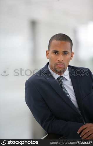 Confident businessman leaning