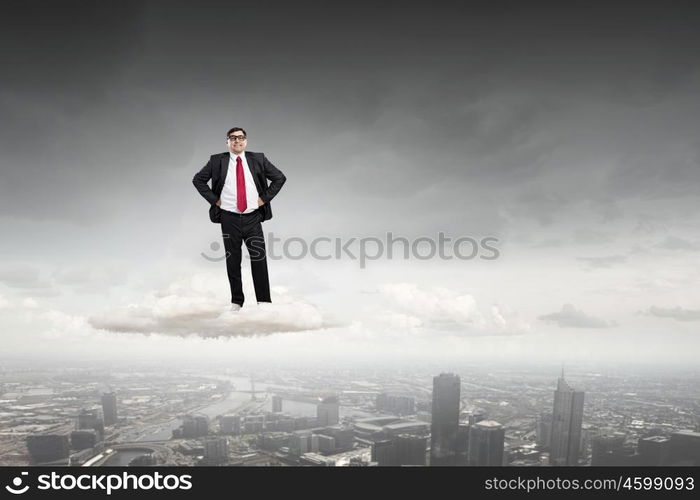 Confident businessman. Middle aged confident businessman hands on waist