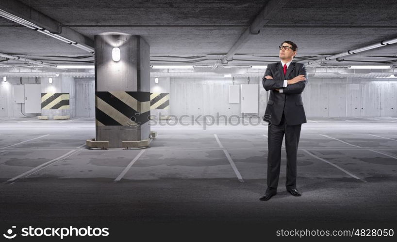 Confident businessman. Middle aged confident businessman with arms crossed on chest