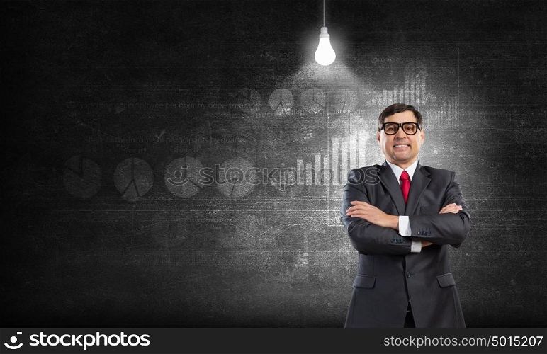 Confident businessman. Middle aged confident businessman with arms crossed on chest