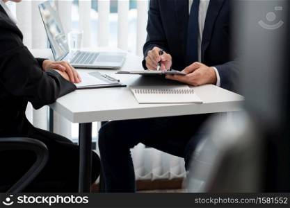 confident businessman sitting in front of office manager talk conducting to interviewer with colleague or boss for business.