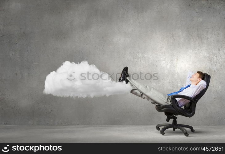 Confident businessman sitting on chair with legs up. Relaxed businessman