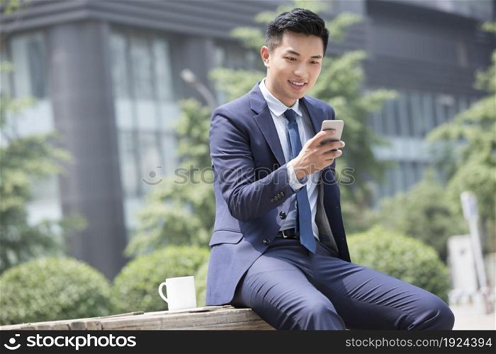 Confident businessman staring at his phone