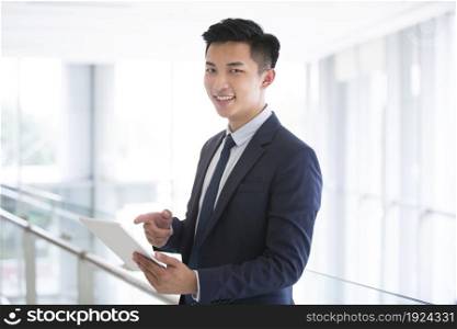 Confident businessman using a tablet computer