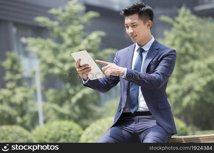 Confident businessman using a tablet computer