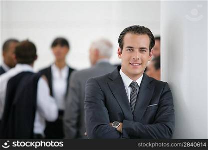Confident businessman with colleagues