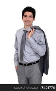 Confident businessman with jacket draped over shoulder