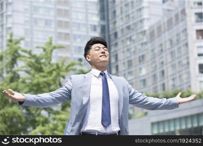 Confident businessman with open arms