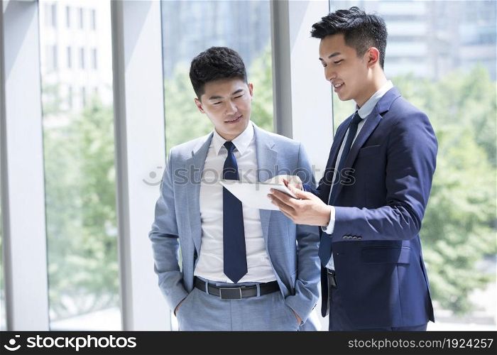 Confident businessmen discussing their work