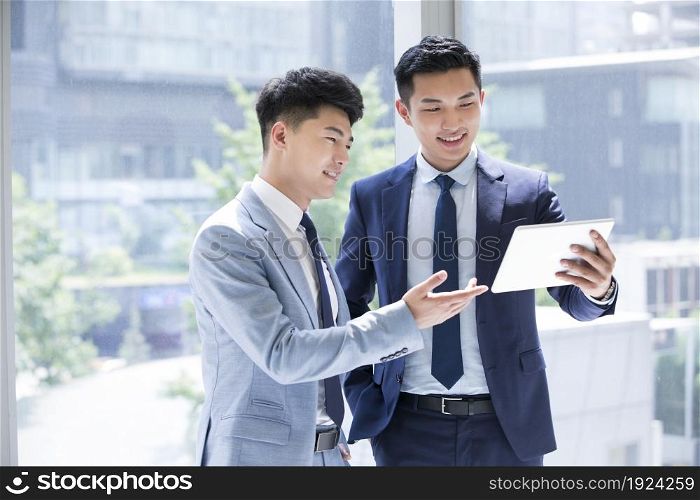 Confident businessmen discussing their work