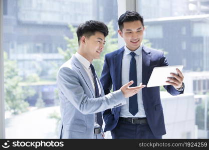 Confident businessmen discussing their work