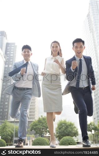 Confident businessmen running
