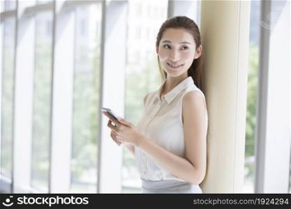 Confident businesswoman holding her phone