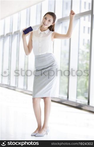 Confident businesswoman holding her phone