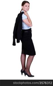 Confident businesswoman holding jacket over shoulder