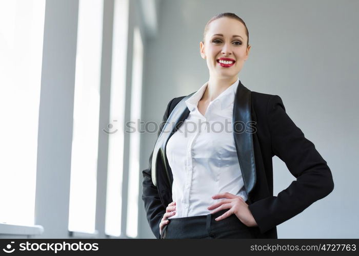 Confident businesswoman. Image of young attractive businesswoman in business suit smiling