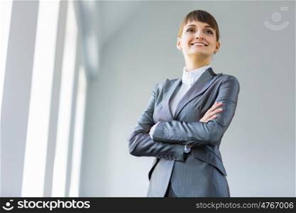 Confident businesswoman. Image of young attractive businesswoman in business suit smiling
