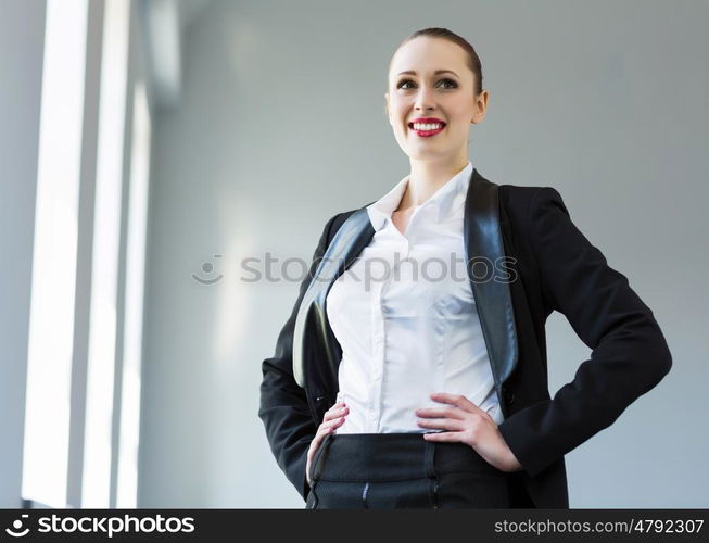 Confident businesswoman. Image of young attractive businesswoman in business suit smiling