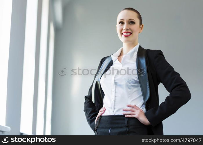 Confident businesswoman. Image of young attractive businesswoman in business suit smiling