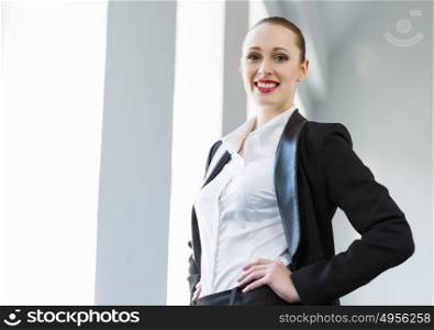 Confident businesswoman. Image of young attractive businesswoman in business suit smiling