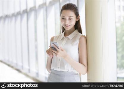 Confident businesswoman staring at her phone