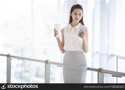 Confident businesswoman staring at her phone