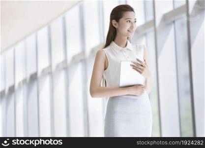 Confident businesswoman using a tablet computer