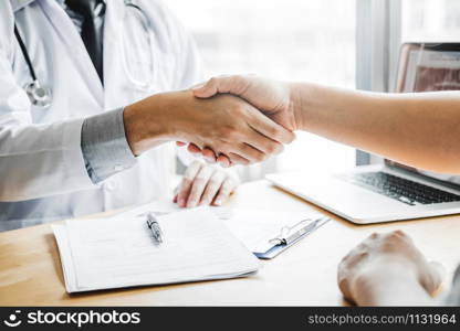 Confident Doctor shaking hands with patients talk in the hospital