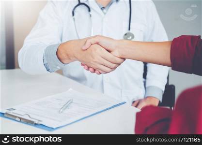 Confident Doctor shaking hands with patients talk in the hospital