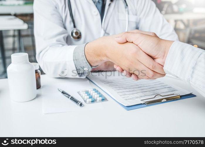 Confident Doctor shaking hands with patients talk in the hospital